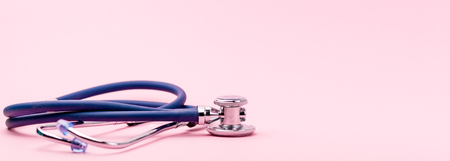 Selective focus of blue stethoscope on pink background. For check heart or health check up concept.. Copy spaceの写真素材