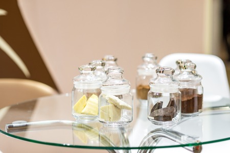 Regular and alkalised cocoa powder on with dar chocolate, in glass jars with lidsの写真素材