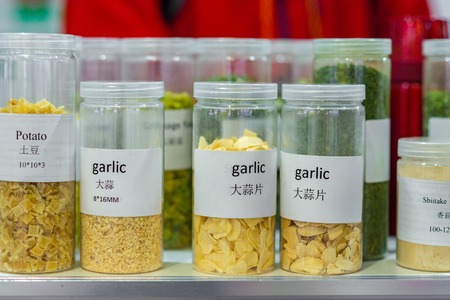 Dried vegetables in glass jars, onions, beets, carrots, pumpkin, bay leaf, banks on wooden background. Superfoods herbsの写真素材