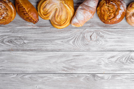 delicious sweet browned cakes bakery products on wooden table. Top view, copy space.の写真素材