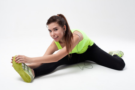 Young beautiful sports girl stretchingの写真素材