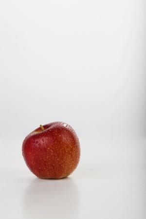 red apple with waterdrop on white background, with selective focus. Space for text.の写真素材