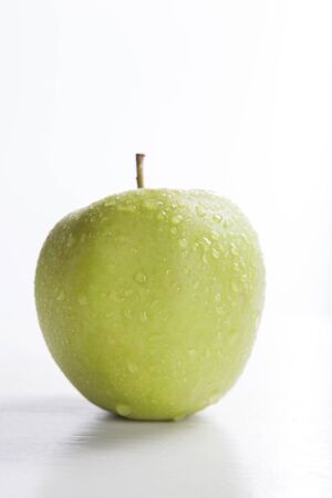 green apple on white background, with selective focusの写真素材