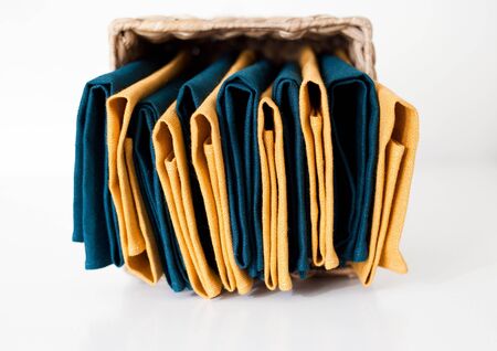 Linen napkins stack in white background. Yellow dominatingの写真素材