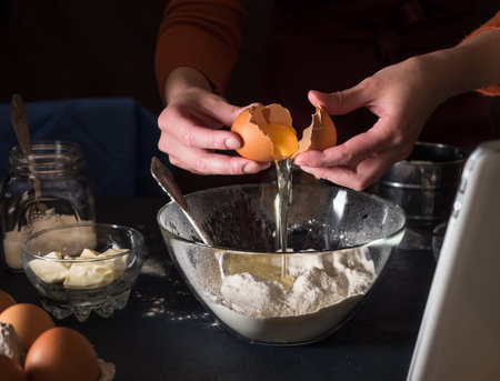 Preparing a cake recipe. We look at the recipe in the tablet. Break the eggs into a bowl. Pouring...