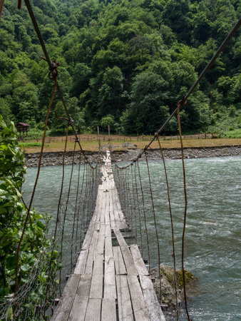 Wooden suspension bridge over the river. No peopleの写真素材