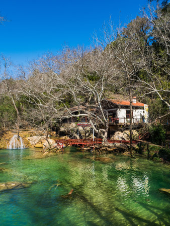 House in the mountains of Turkey next to a mountain river. Clear water, waterfalls, beautiful nature. Vacation, travel concept. Place for design, text. No people, Vertical. Sunnyの写真素材