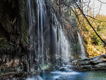 Water flows downstream from the waterfall from the mountains.の写真素材