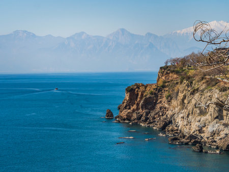 Beautiful view of a mountain cliff, a mountain cliff into the sea. Blue ocean. Beautiful landscape. Mountains in the background. No people. Place for text, copy space. Endless travel conceptの写真素材
