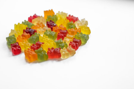 hight angle view of a pile of colorful gummy bears on a light background close upの写真素材