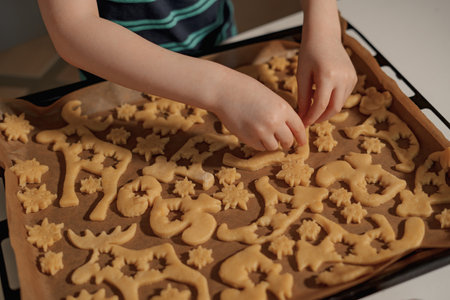 boy makes christmas cookies with caramel to celebrate christmas with his family
