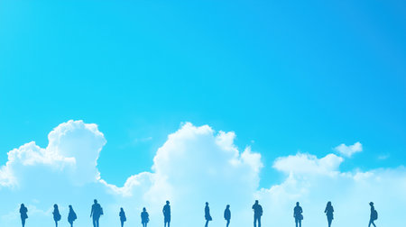 A group of people are silhouetted against a blue skyの素材