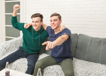 fans are drinking and watching TVの写真素材