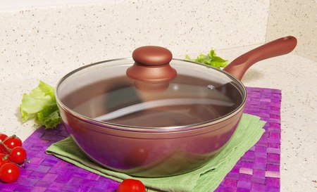 Frying pan on the kitchen tableの写真素材