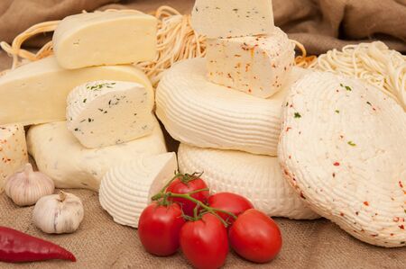 Rennet cheese with vegetables and herbsの写真素材