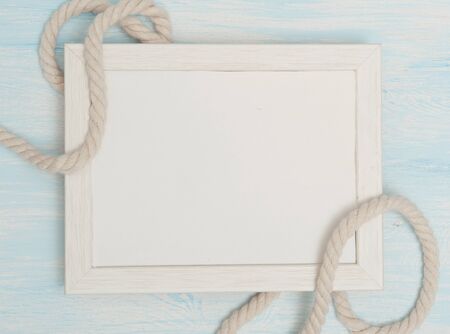 Sea background with frame and blue painted wood, rope, starfish, shellsの写真素材