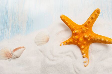 Sea background with white sand and blue painted wood, starfish, shellsの写真素材