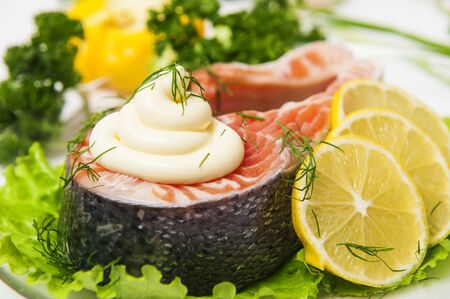 Salmon fish with lemon on lettuceの写真素材