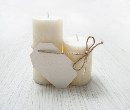 Gift card with candles on a wooden white table. Romantic compositionの写真素材