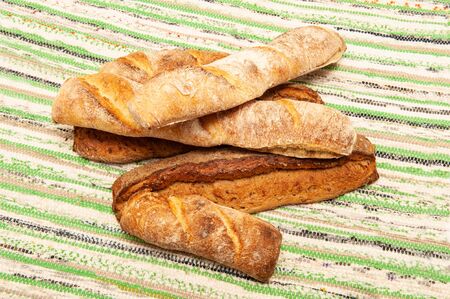 French different loaves lying on a rustic woven rug