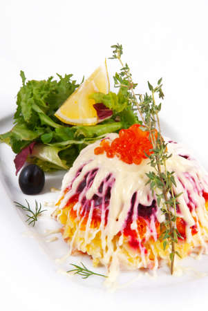 Herring salad under a fur coat on a white background