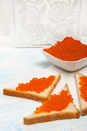 Toasts with red caviar and bowl with caviarの写真素材