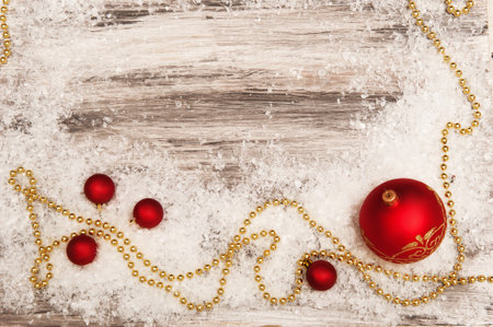 red and white Christmas decorations on a gray background with artificial snowの写真素材