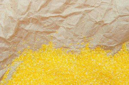Abstract background with ground corn on crumpled old parchment wrapping paperの写真素材