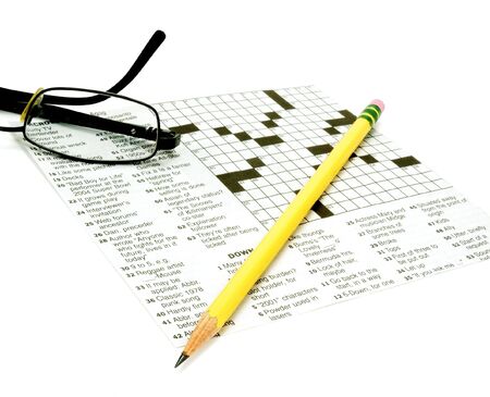 Glasses and pencil on crossword puzzleの写真素材