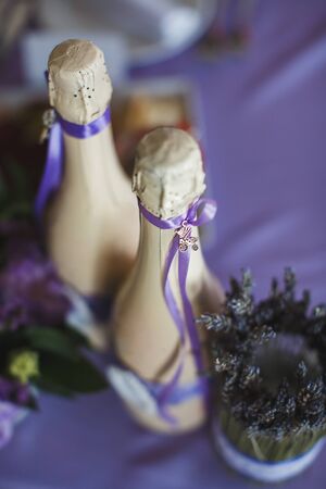 Two decorated bottles of champagne on the wedding celebration.の写真素材