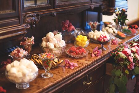 Sweet table with marshmallows, marmalade, cookies and sweets. Candy bar.の写真素材