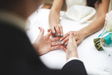 Bride and groom walking together holding their handsの写真素材