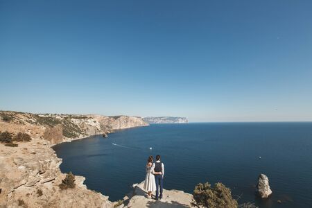 bride and groom on the precipice of the mountain. the ocean. seaの写真素材