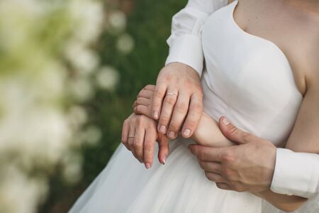 Bride and groom walking together holding their handsの写真素材