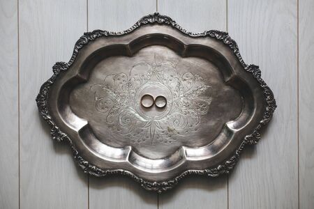 The wedding rings on a metal trayの写真素材