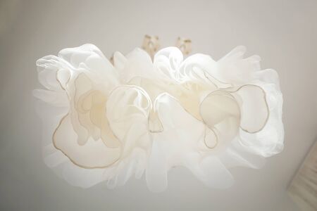Elegant white wedding dress on a hanger.