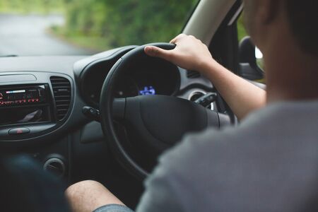 The man behind the wheel of a car. Hands close -up.の写真素材