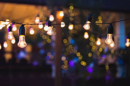 outdoor string lights hanging on a line in backyard