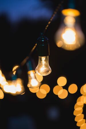 outdoor string lights hanging on a line in backyardの写真素材