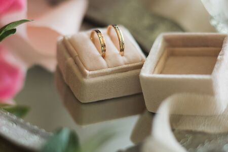 Gold wedding rings in a box on the table.の写真素材