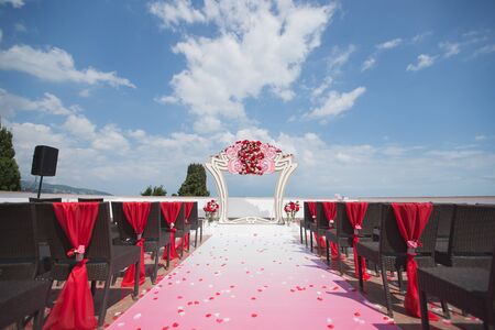 Arch red for the wedding ceremony in the sea. Mountain.の写真素材