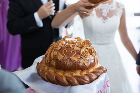 The bride and groom break the wedding loaf
