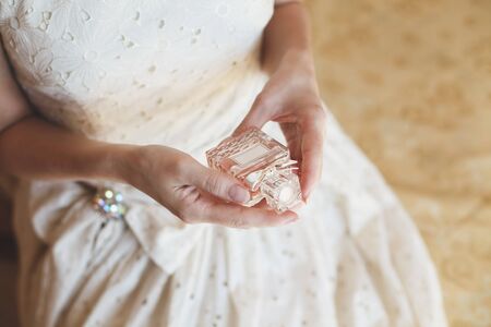 A blonde bride in a wedding dress enjoys perfumeの写真素材