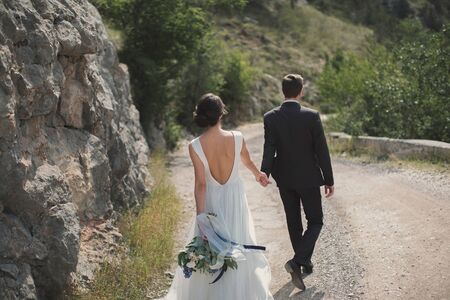 The couple hand in hand go to family lifeの写真素材