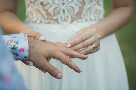 Bride wears a wedding ring on the groom's finger