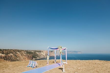 Wedding arch pink color on the background of the sea.の写真素材