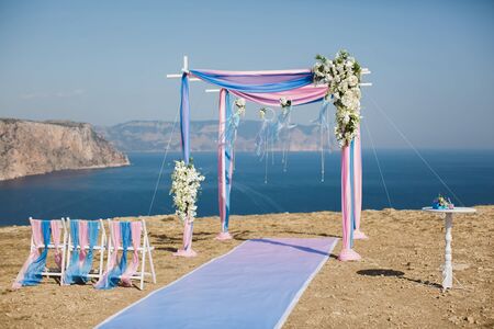Wedding arch pink color on the background of the sea.の写真素材