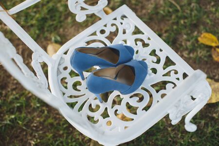 Beautiful womens wedding shoes on a chair.の写真素材