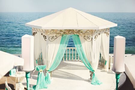 Wedding arch in blue color on the beach.の写真素材
