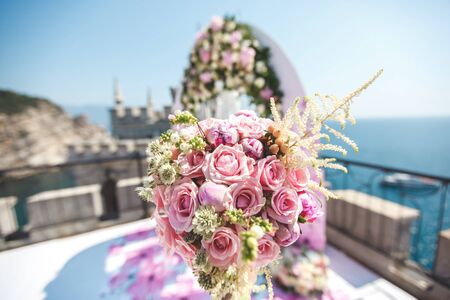Wedding arch pink color with chandelier and flowers